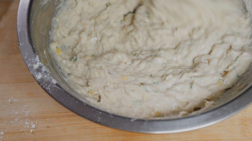 Mix ingredients together in a bowl. When adding water to the batter mix, do so very slowly as the batter can easily become too wet. Be sure to season with a bit of salt and black pepper.
