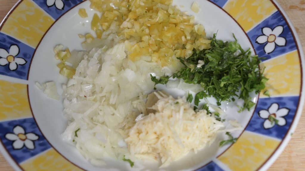 Finely chop veggies while your saltfish is boiling.